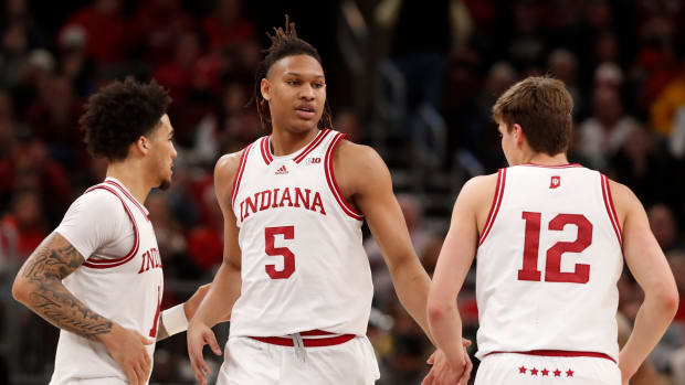 Hoosiers guard Jalen Hood-Schifino (1), forward Malik Reneau (5) and forward Miller Kopp (12) high-five during the Big Ten Men's Basketball Tournament.